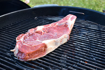 High angle view of meat on barbecue grill