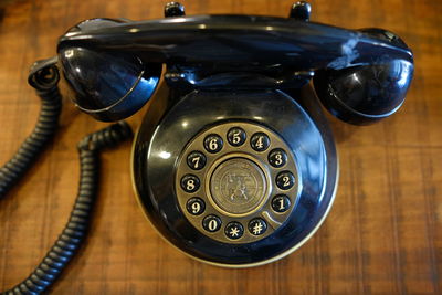 Close-up of rotary phone on table