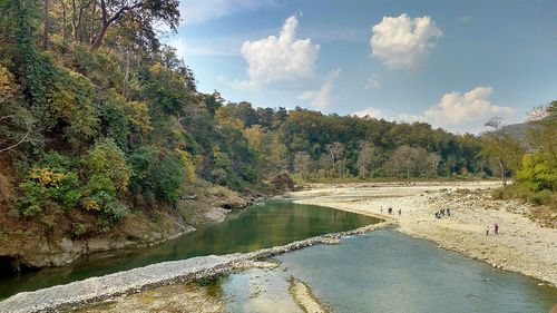 Scenic view of lake by trees against sky