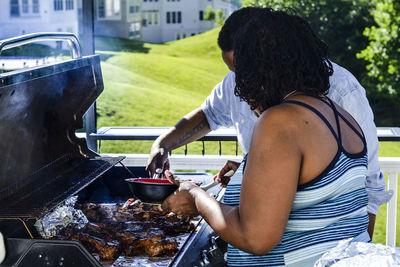 Man sitting on barbecue grill