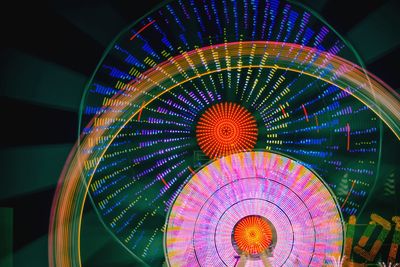 Low angle view of illuminated ferris wheel