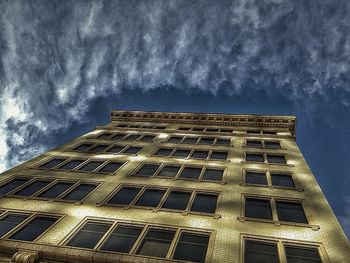 Low angle view of building against cloudy sky