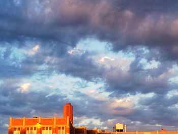 Low angle view of building against cloudy sky