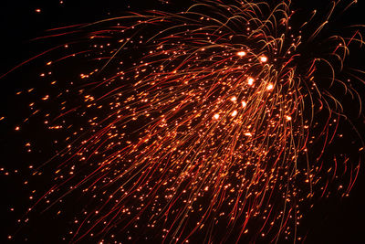 Low angle view of firework display at night