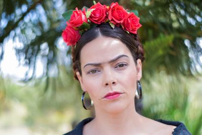 Portrait of beautiful woman with red flower tiara