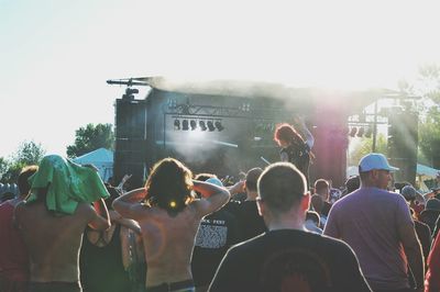 People enjoying at music concert in sunny day