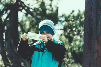 Portrait of cheerful boy showing paper currency