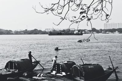 View of fishing boats in sea against clear sky