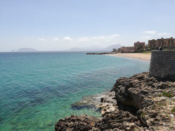 Scenic view of sea against cloudy sky