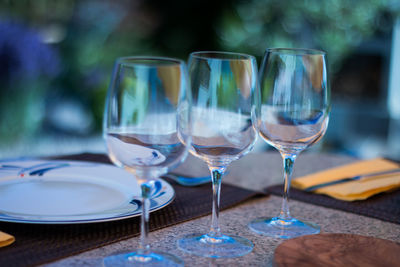 Close-up of wine glasses on table