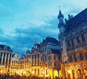 Low angle view of illuminated buildings against sky