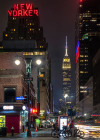 Illuminated city street and buildings at night