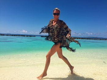 Full length of woman standing on beach