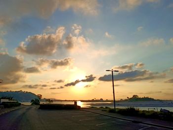 Street against sky during sunset