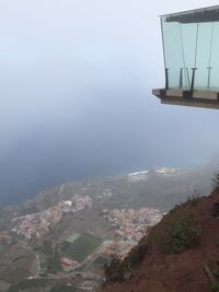 High angle view of townscape by sea against sky