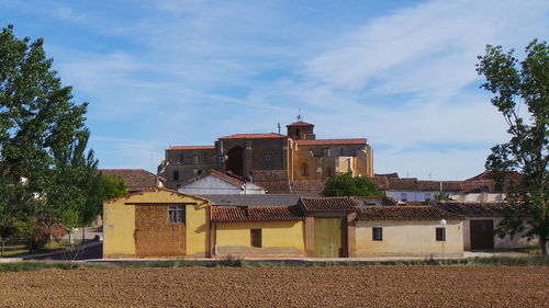 Buildings against cloudy sky