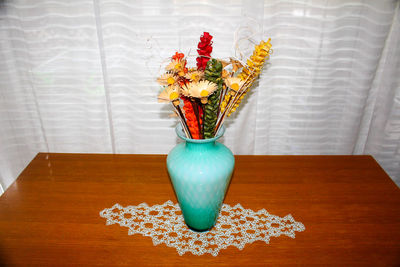 Close-up of wooden flower vase on table