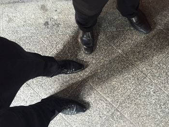 Low section of men standing on floor