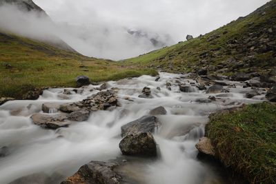 Scenic view of stream amidst land