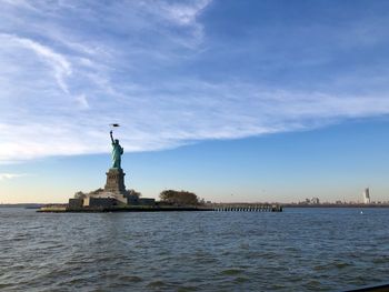 Statue of liberty against cloudy sky