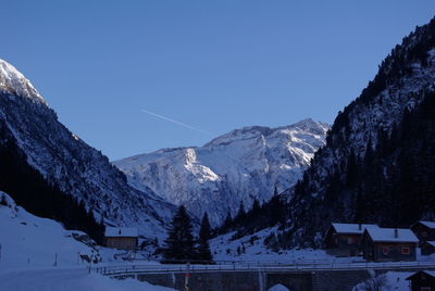 Scenic view of snowcapped mountains against clear blue sky