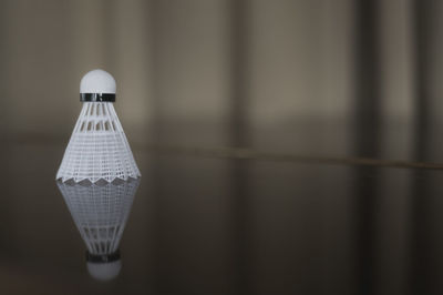 Close-up of shuttlecock on badminton court