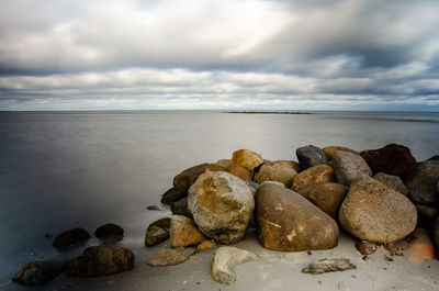 Rocks on beach against sky