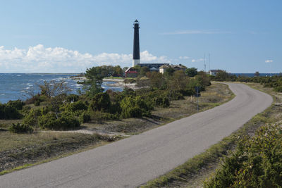 Lighthouse on shore against sky