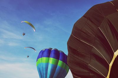 Low angle view of balloons flying against sky