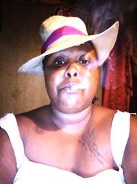 Portrait of mature woman wearing hat at home