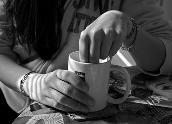 Close-up of woman holding coffee cup