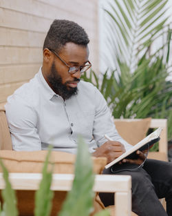 Business person writing in diary