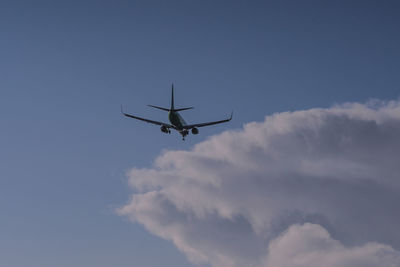 Low angle view of airplane flying in sky