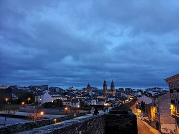 High angle view of illuminated buildings against sky at dusk