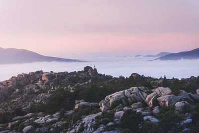 Rock formations against sky during sunset