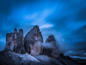 Scenic view of rock formation against sky during winter