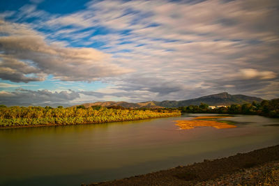 Scenic view of lake against sky at sunset