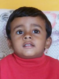 Close-up portrait of cute boy at home