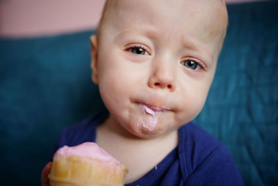 Child eats pink ice cream
