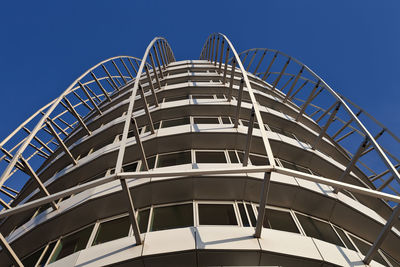 Low angle view of modern building against blue sky