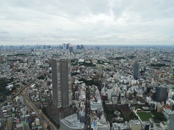 High angle view of modern buildings in city against sky