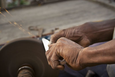 Midsection of man working at workshop