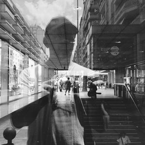 People walking in city against sky