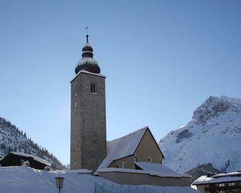 Low angle view of church against clear sky during winter