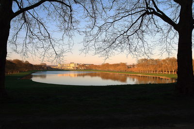 Scenic view of lake against sky at sunset