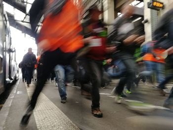 Blurred motion of people walking on road