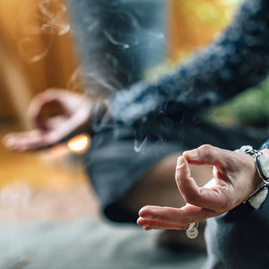 Woman meditating while exercising at home