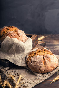 Close-up of bread on table against black background