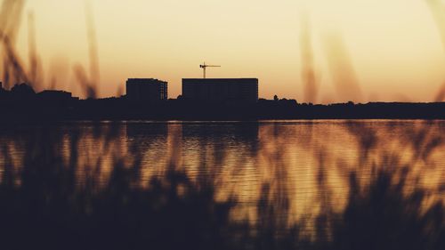 Scenic view of silhouette buildings against sky during sunset