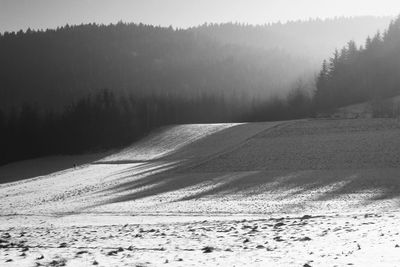 Scenic view of landscape against sky during winter